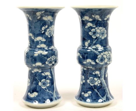 A PAIR OF CHINESE BLUE AND WHITE CYLINDRICAL VASES PAINTED WITH PRUNUS ON A CRACKED ICE GROUND, 19.5CM H, KANGXI MARK, LATE 1