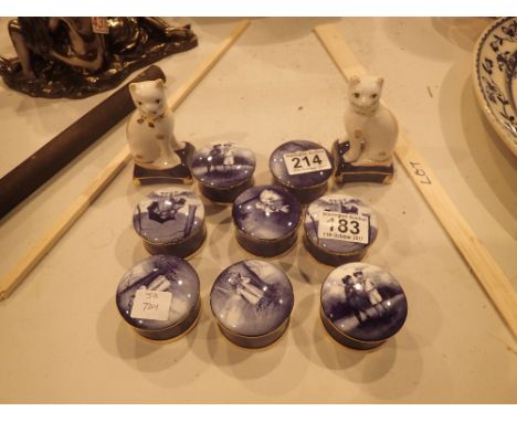 Eight lidded pots and a pair of ceramic cats