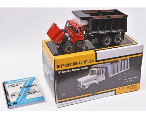 A First Gear 1:25 scale International 'S' Series Dump Truck. Presented in red with a black body. Rotating driveshaft, detaile