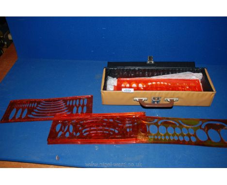 An Instrument case containing eight sets of French (Minerva) architectural Draughtsman's plastic eclipse template from 15 deg