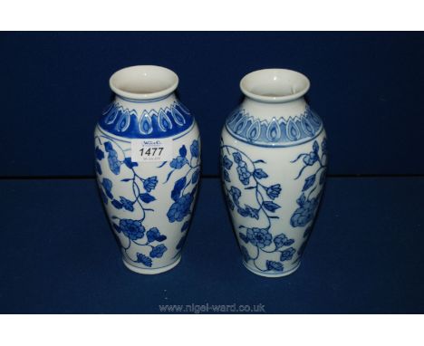 A pair of 20th c. Chinese ceramic blue and white baluster shape Vases in trailing peony pattern, 8" tall.