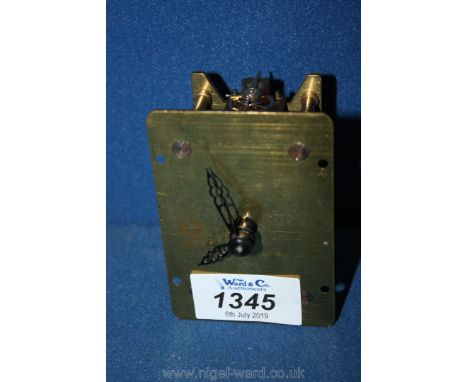 A small brass clock face and movement Davall made in England.