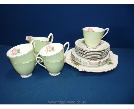 A Royal Albert part Teaset in pale green with pink roses; five cups, six saucers, six plates, bread and butter plate, sugar b