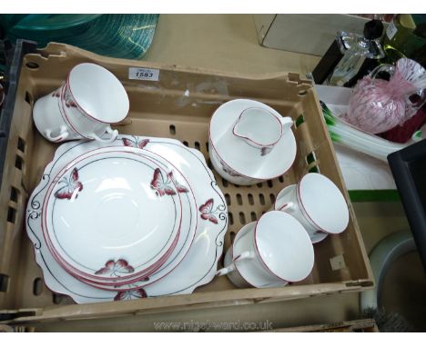 A Wellington china part Coffee set with pink butterfly design, consisting of six cups and saucers, six tea plates, bread and 