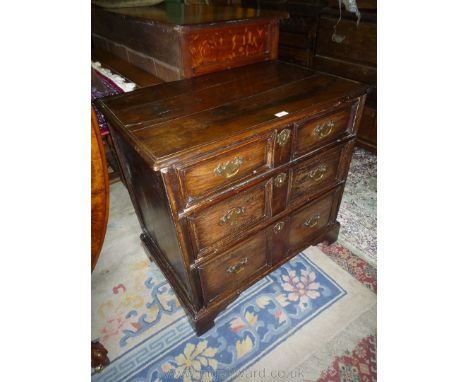 A compact 18th c. Jacobean style Oak Chest of three long drawers standing on bracket feet and having brass drop handles and l