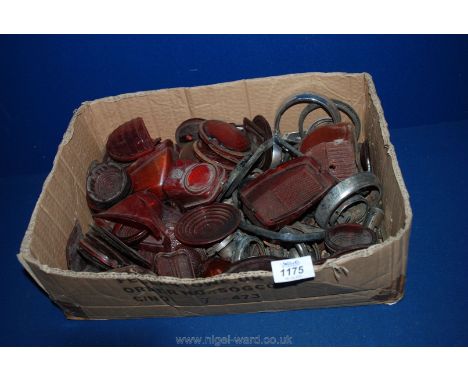 A box of vintage car parts including lamp bodies, lenses etc.