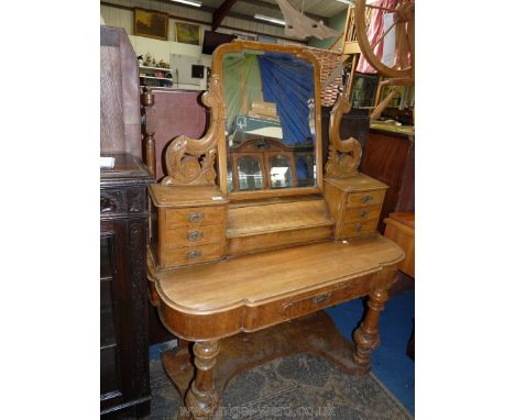 A Victorian satinwood Duchess style dressing Table, the swing mirror supported on a base with two flights of three trinket dr