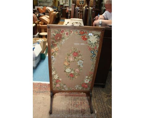 A Walnut framed tapestry Firescreen, 23 3/4" wide x 46 1/2" high.