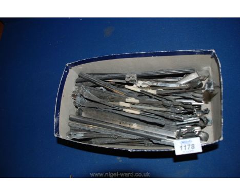 A box of vintage car parts including windscreen wipers.