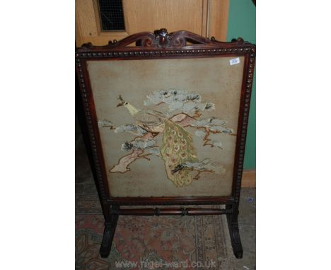 A large Victorian Firescreen with peacock embroidery.