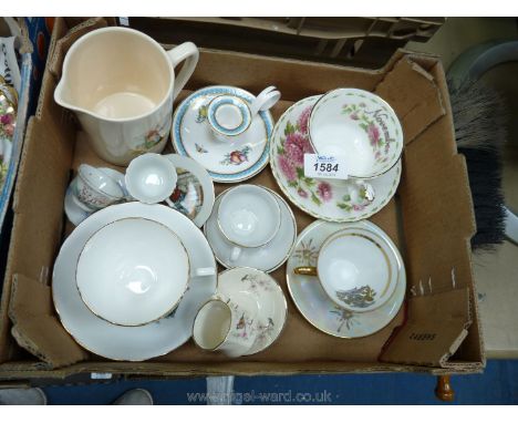 A box of cups and saucers including Royal Albert, Palissy, etc., along with a Welsh jug.