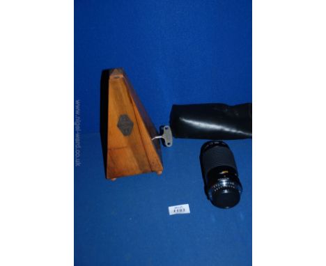 A metronome and camera lense in case.
