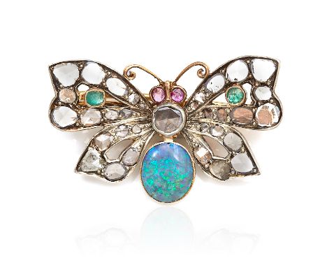 A VICTORIAN OPAL, DIAMOND, EMERALD AND RUBY BUTTERFLY BROOCH in yellow gold, set with a central cabochon opal, jewelled with 