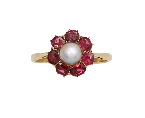 AN ANTIQUE PEARL AND RUBY DRESS RING in high carat yellow gold set with a central pearl of 5.0mm encircled by a border of rub