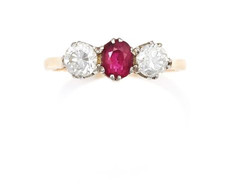 AN ANTIQUE RUBY AND DIAMOND THREE STONE RING in 18ct yellow gold and platinum, the central oval cut ruby of 0.75 carats set b