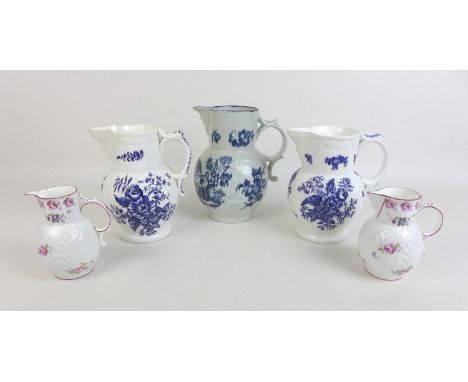 A group of five face mask jugs, comprising three blue and white decorated with sprays of flowers, Salopian Coalport, Caughley