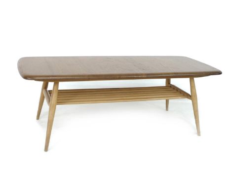 An Ercol beech and elm coffee table, circa 1960, the surface of rectangular form with rounded corners, raised on turned outsp