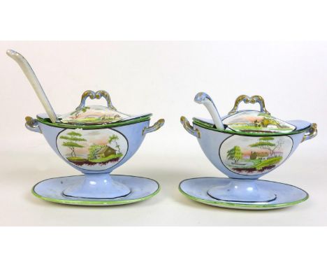 A Victorian part serving service, decorated with reserves of landscape views against a pale blue ground, green and black rims
