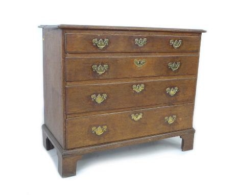 A George III oak chest of four graduating drawers, brass plate handles and escutcheons, raised on bracket feet, 92 by 48 by 7