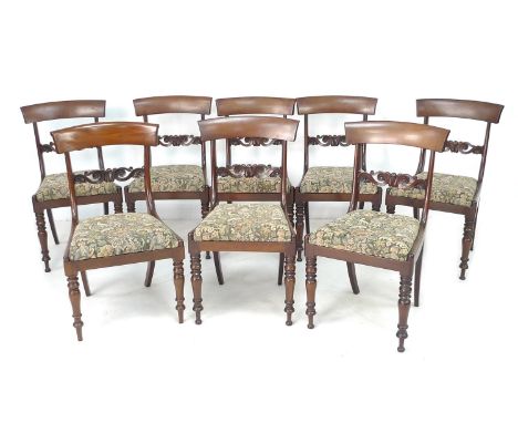 A set of Regency mahogany bar back dining chairs, tapestry drop in seats, with carved mid-rail, turned front and sabre rear l