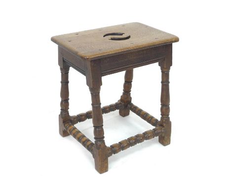 An 18th century oak coffin stool, with cut out handle to seat, bobbin turned legs, 46 by 31 by 51cm high. 