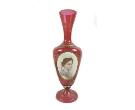 A 19th century Continental cranberry glass vase, of baluster form on circular foot, decorated with an oval reserve portrait o