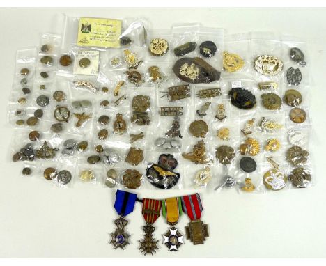 A large collection of military cap badges, buttons and medals, including some WWI and WWII pieces, featuring Reconnaissance C