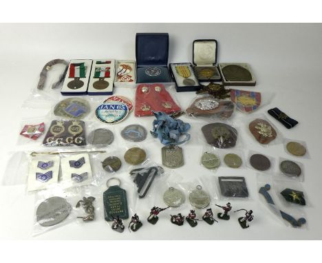 A collection of medals, medallions and badges, including two Kuwait Liberation medallions, a Mixed Service Organisation badge