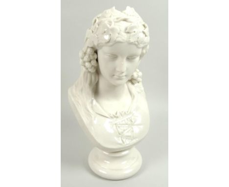 A late Victorian Belleek bust, modelled as 'Queen of the Hops', with foliate hair decorations, raised upon a circular socle, 