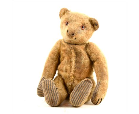 A Steiff mohair teddy bear, jointed limbs, glass eyes, hump back, with original Steiff button in eye, 24cm full length, worn 