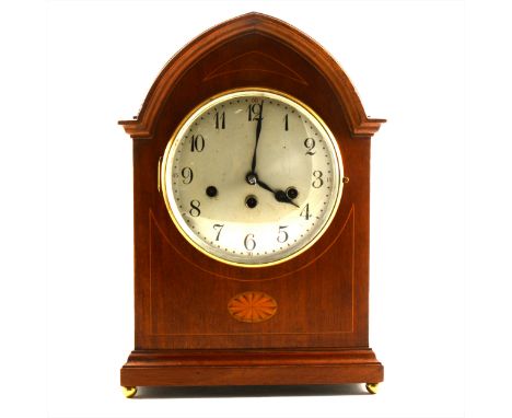 An Edwardian mahogany mantel clock, inlaid lancet case, silvered dial, Junghans movement striking on five gongs, 39cm.