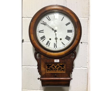 A drop dial twin train wall clock with 28cm white enamel dial, 70cm mahogany case, striking on a gong, fret panel to glazed d