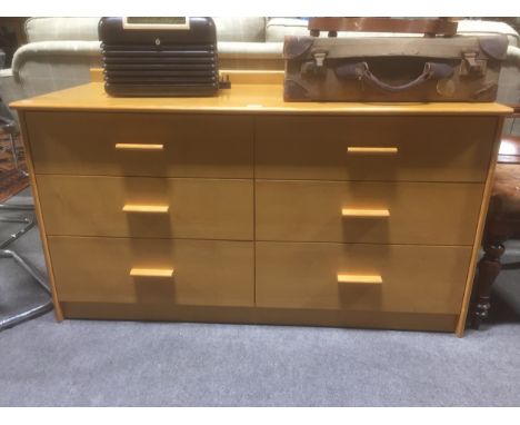 A modern light oak finish chest of drawers, fitted with two banks of three drawers, width 127cm.