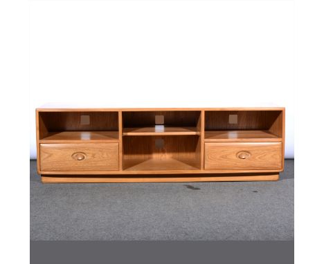 An Ercol light elm media centre, with open shelves and drawers, length 157cm.