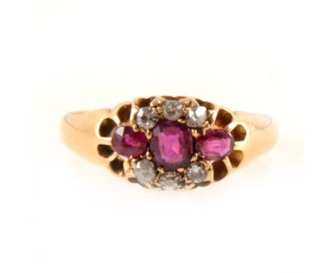 A ruby and diamond ring, three rubies claw set horizontally and bordered by three old cut diamonds to top and bottom in an 18