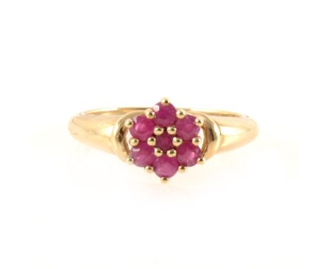 A ruby cluster ring, the seven round rubies claw set as a circular floral cluster in a 9 carat all yellow gold mount with pol