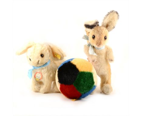 Two Steiff Germany rabbit teddies, one sitting 19cm tall with button and tag, one with basket on its back 24cm, and a Steiff 