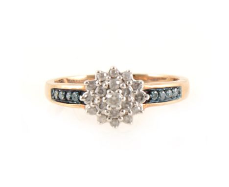 A circular diamond cluster ring with blue diamond shoulders, nineteen brilliant cut diamonds claw set as a 9mm circular clust