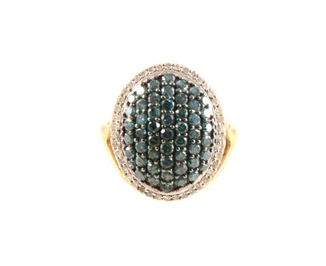 A blue and white diamond oval cluster ring, the oval cluster pavé set with blue/green diamonds and surrounded by white diamon