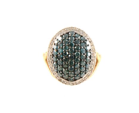 A blue and white diamond oval cluster ring, the oval cluster pavé set with blue/green diamonds and surrounded by white diamon