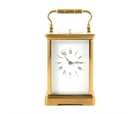 A French brass cased repeating carriage clock, hour repeating, white enamelled dial, platform escapement, striking on a gong,