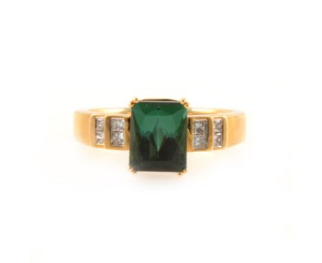 A green tourmaline and diamond ring, the rectangular step cut tourmaline 8.5mm x 7mm, set with four double claws in an 18 car