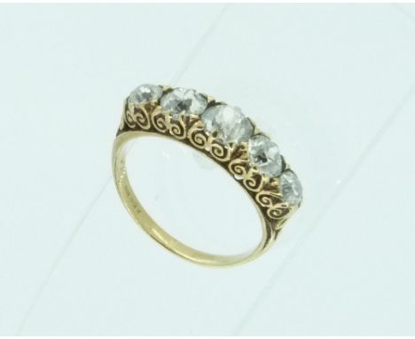 A five stone graduated Diamond Ring, the old cut diamonds c. 1.53cts with a yellow gold scroll mount, the shank marked but no