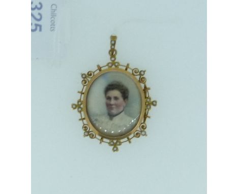 An oval Pendant, the frame in 9ct yellow gold, with wirework and seed pearl border and suspension loop, box and glass front w