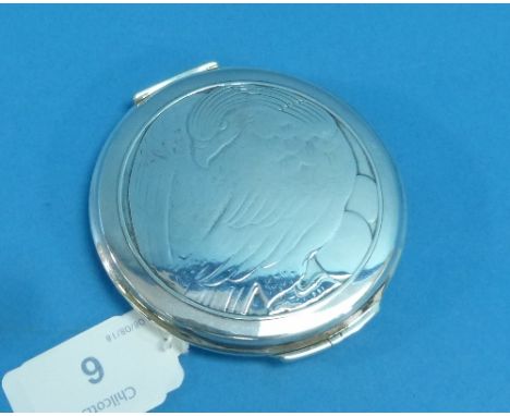 A Georg Jensen silver Compact, circa 1950, of circular form with hinged mirrored lid, the top with image of a nesting eagle, 