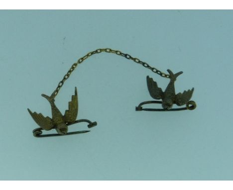 A charming Sweetheart Brooch, in 15ct yellow gold, formed of two swallows, both with brooch pins, one suspended form the othe