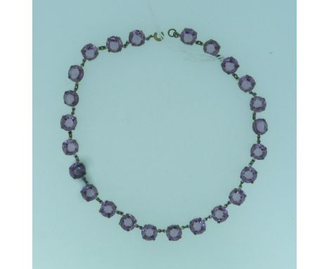 A collet and claw set Necklace, set with twenty four amethyst pastes with small links between each, mounted in gilt metal, op