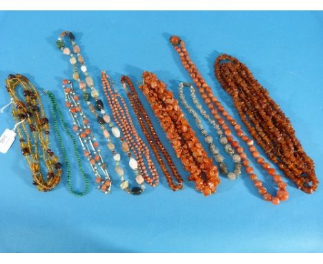 A collection of stone, amber and bead Necklaces, including a long graduated orange striated agate bead necklace with caboucho