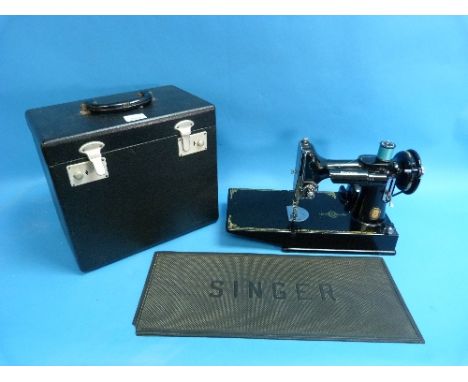 A Vintage 1951 Singer Portable Electric Sewing Machine Model 221K, with rotary hook and reverse feed, serial number EG966275 