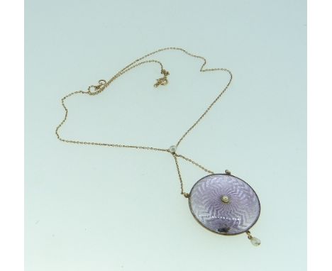A Pendant/ Locket, of circular form, the front with pale mauve guilloche enamel, slight damage, with seed pearl centre and dr